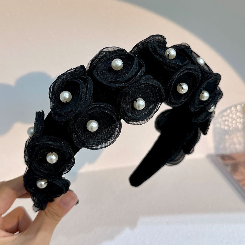 Close detail of glossy pearl centers and matte black petals