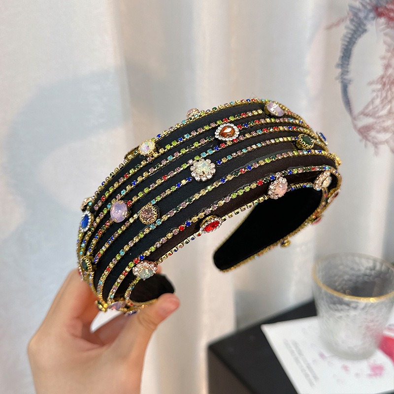 Hand positioning ornate headband to show open structure