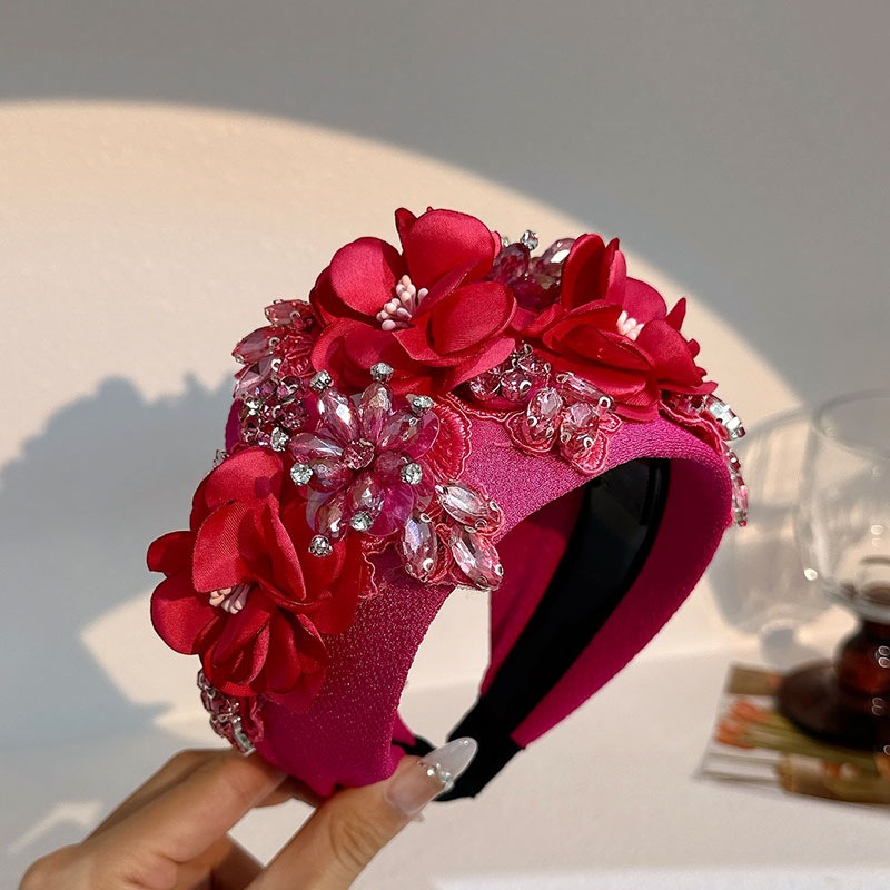 Fuchsia oversized headband showing dramatic floral scale