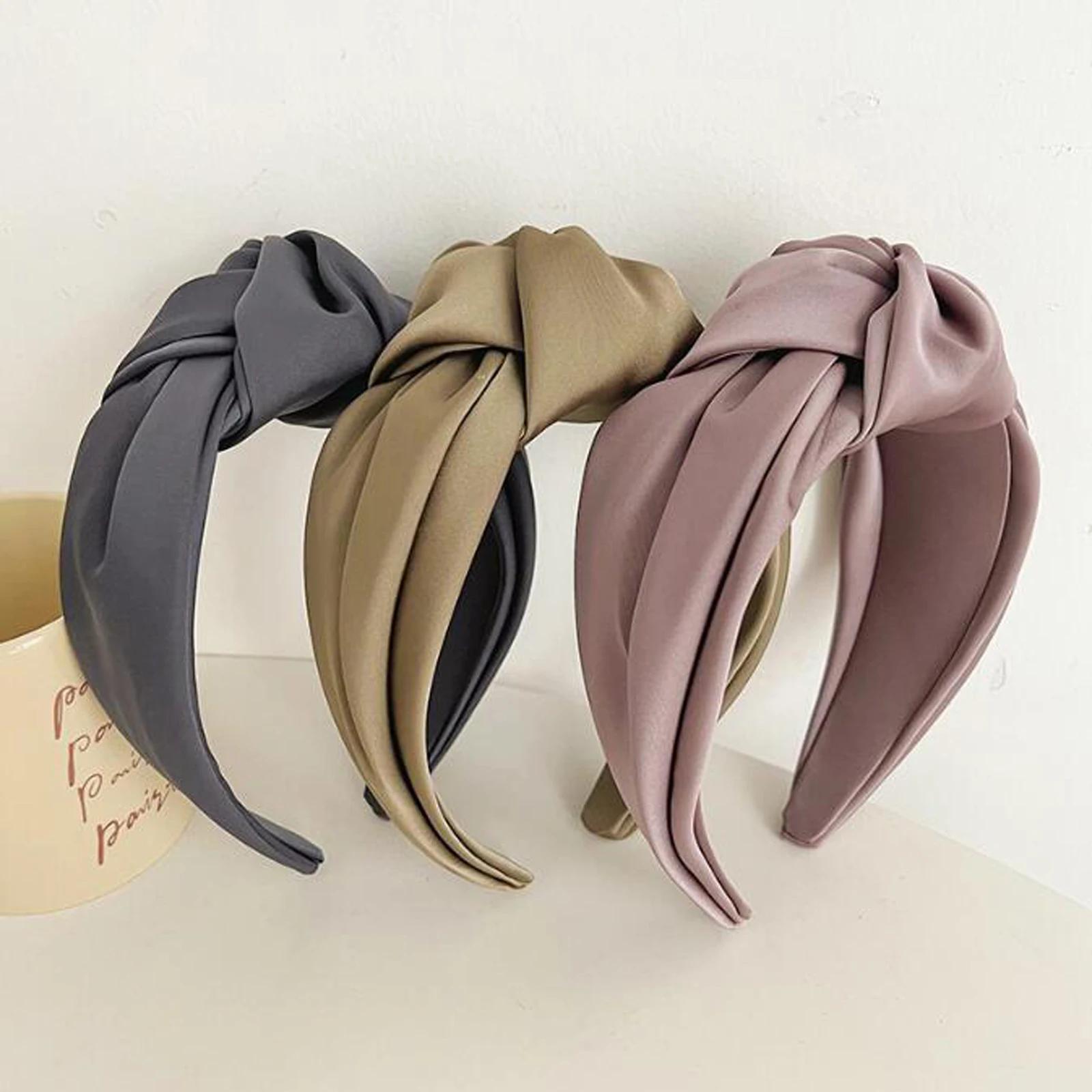 Neutral satin headbands showing smooth lustrous surface