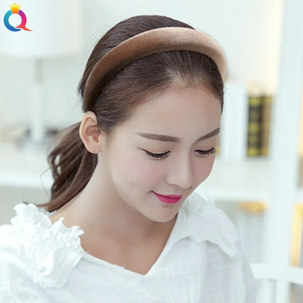 Woman styling hair with broad brown velvet hoop