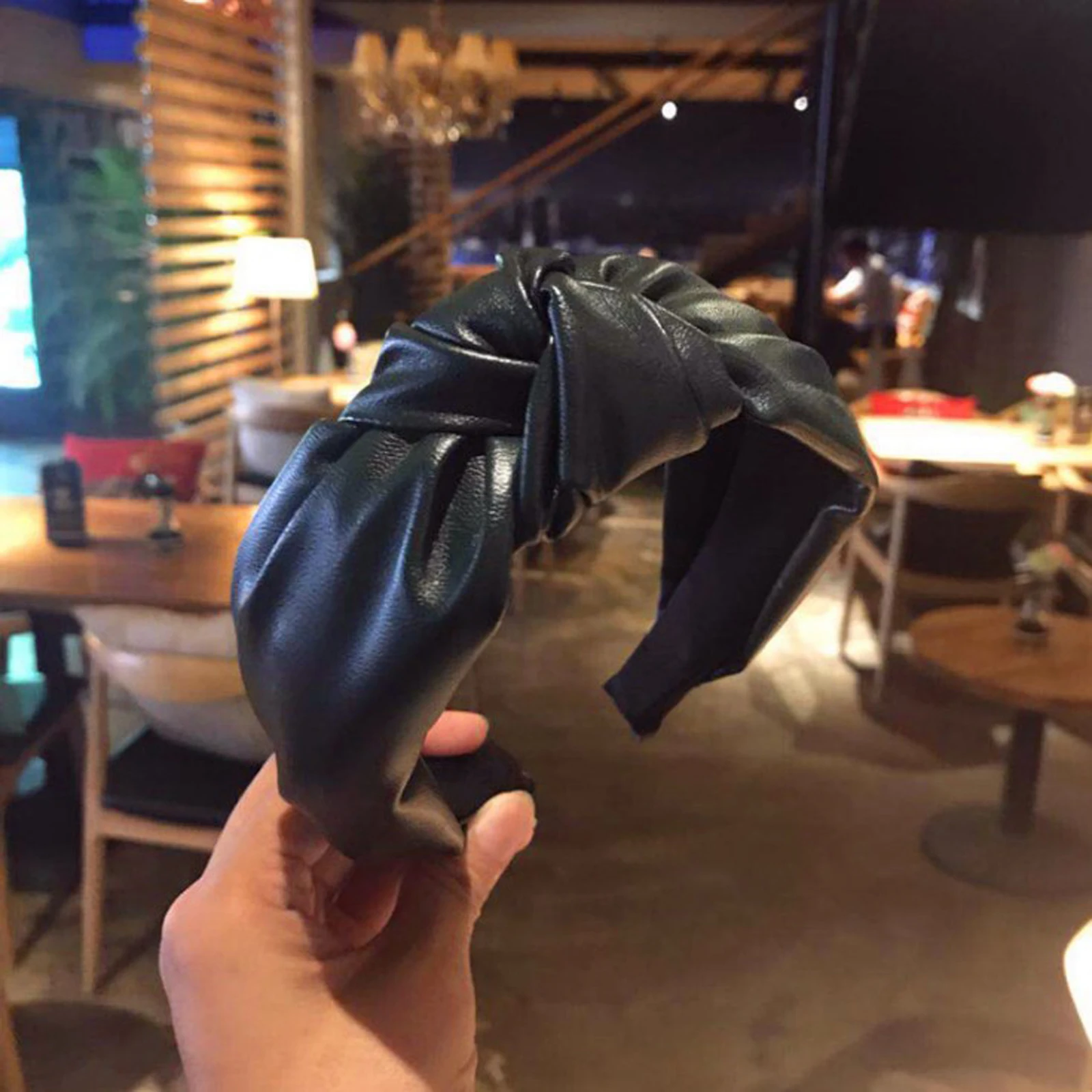 Black headband highlighting folded gathered crown