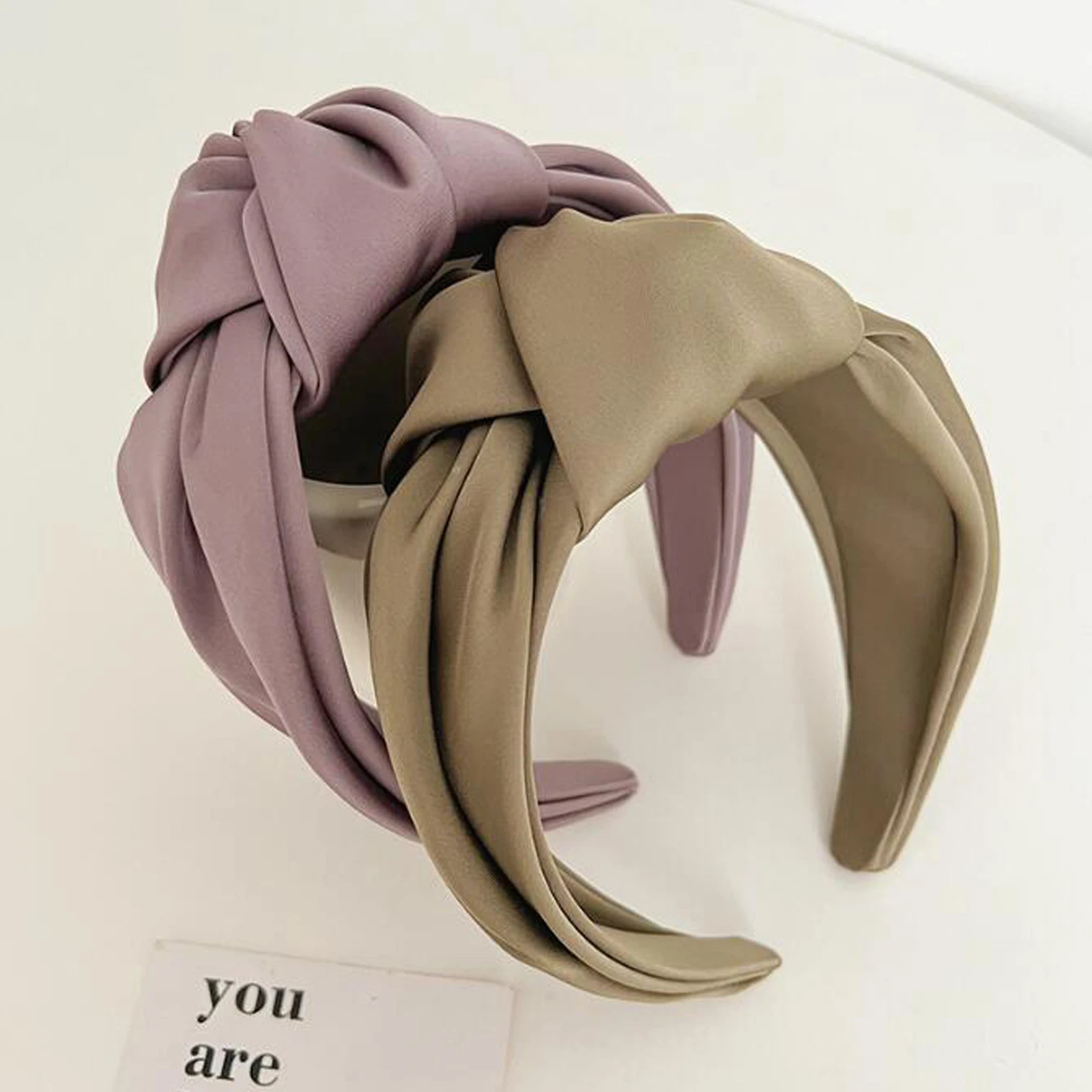 Gathered satin knot with dimensional layered fabric folds