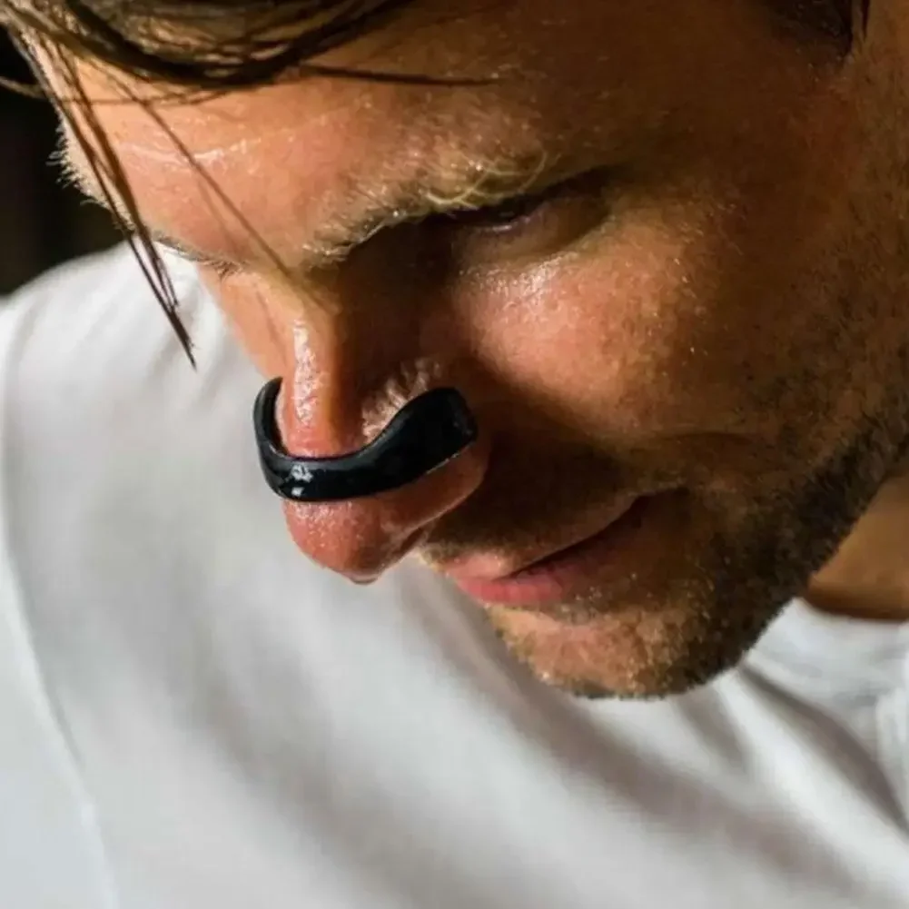 Close-up of magnetic nasal clip in use on man's nose, showing proper fit and comfortable positioning
