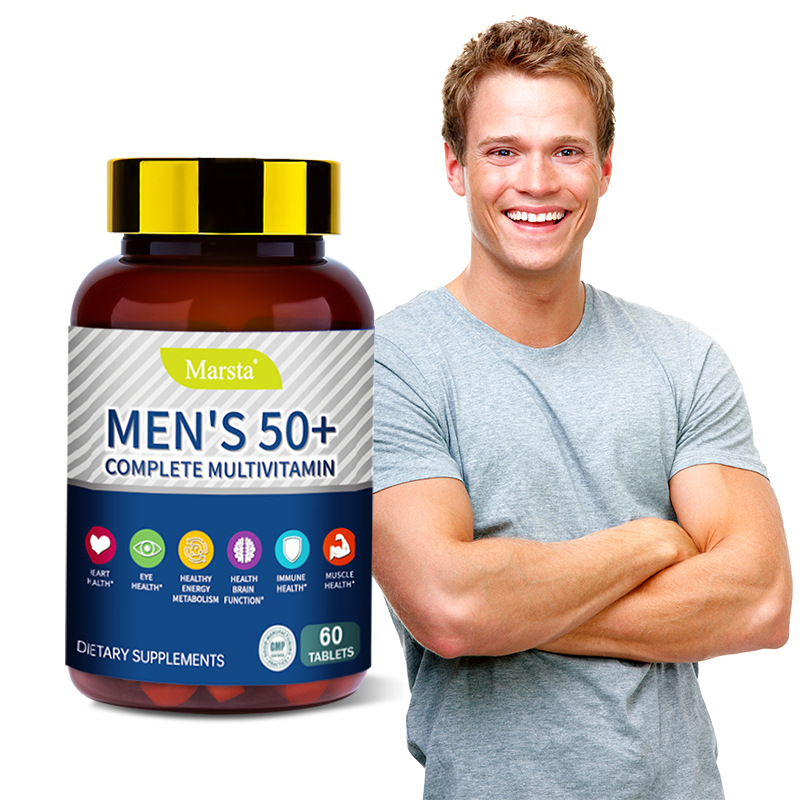Confident middle-aged man in gray t-shirt smiling with arms crossed next to Marsta Men's 50+ multivitamin bottle