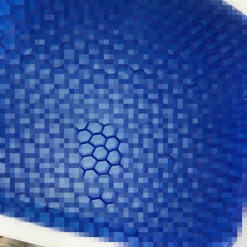 Extreme close-up of egg-crate hexagonal texture pattern on gel surface