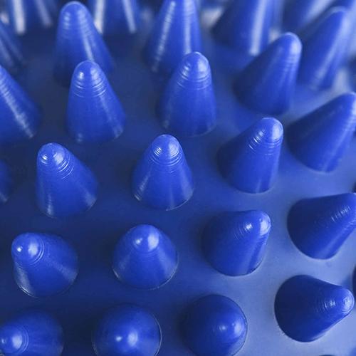 Close-up macro photograph of individual cone-shaped PVC spikes with glossy surface