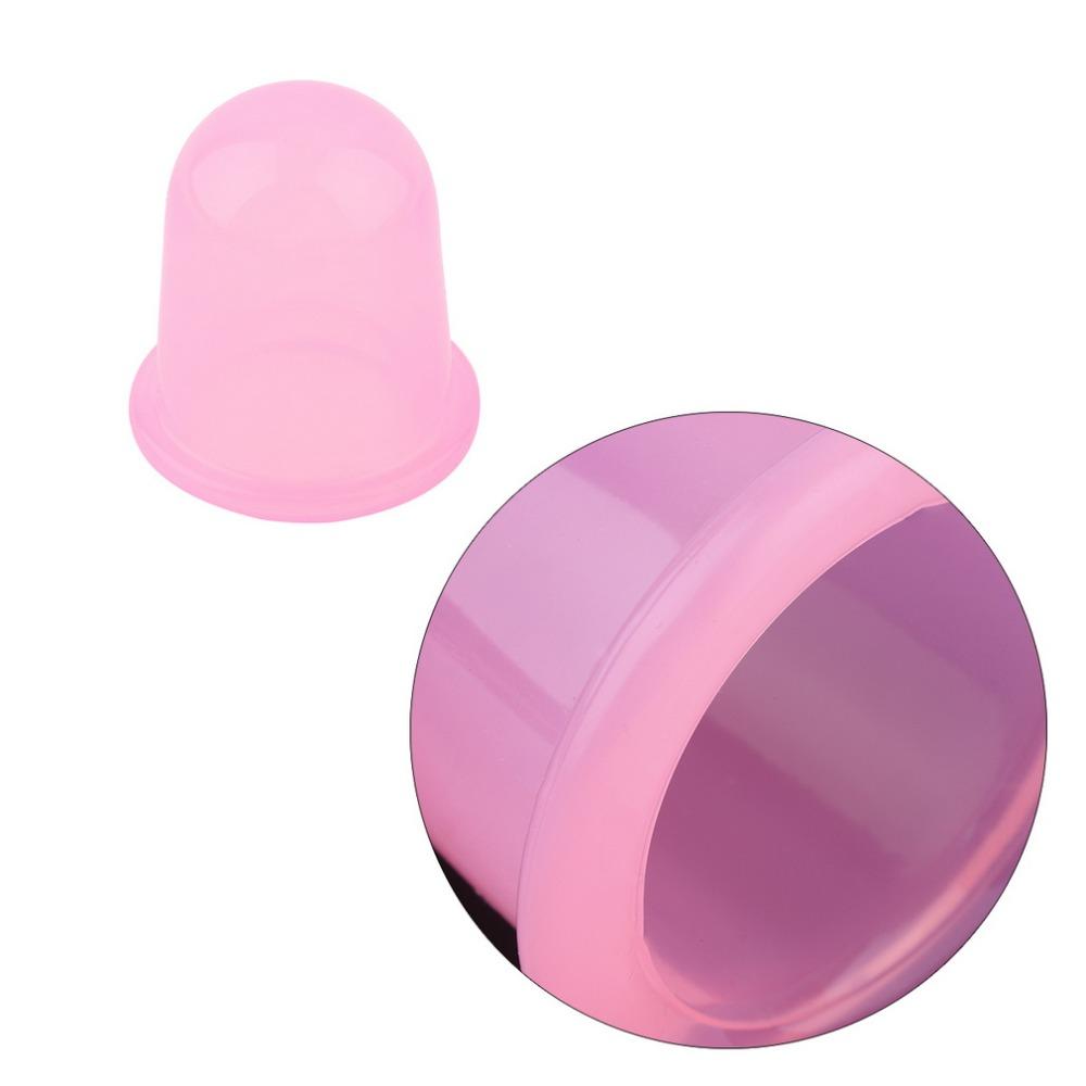 Single pink cup held by fingertips, showing the hollow bell shape and wide rim