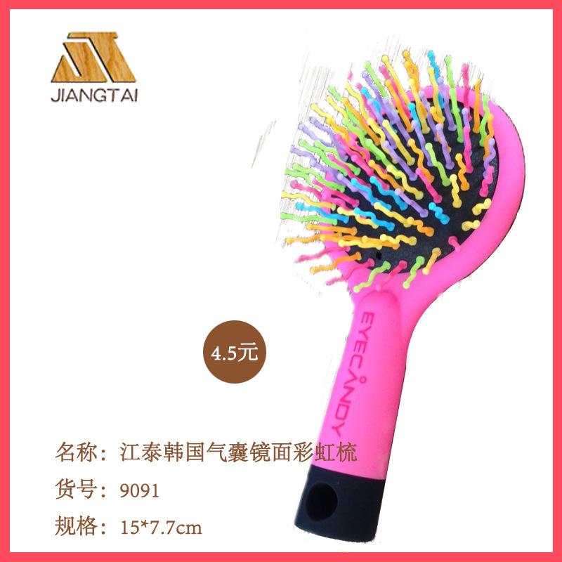 Side view of pink brush with flexible wavy bristles