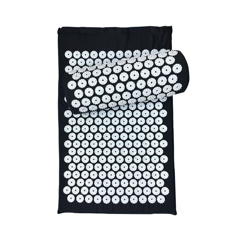 Black acupressure mat folded with carrying strap, symbolising personal freedom and daily transformation