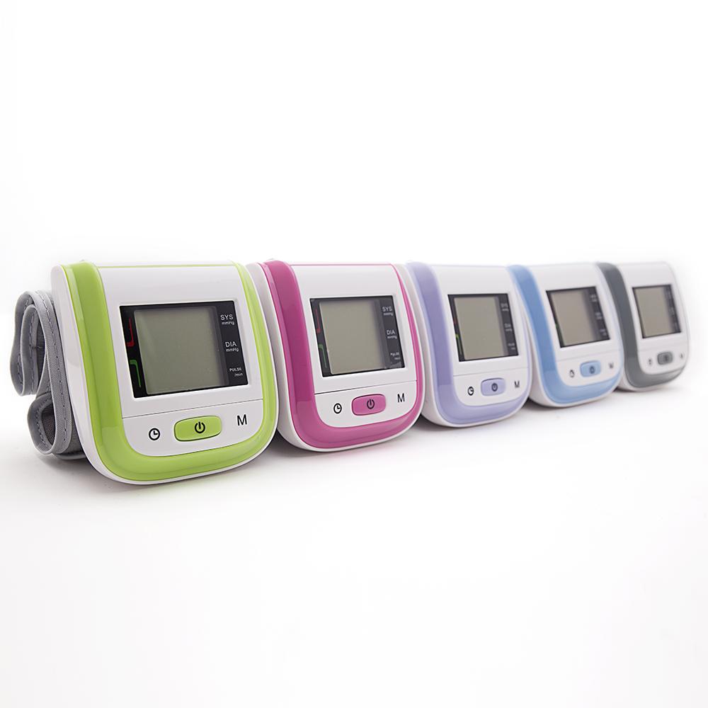 Lineup of five blood pressure monitors in different colors: lime green, magenta pink, lavender purple, sky blue, and gray