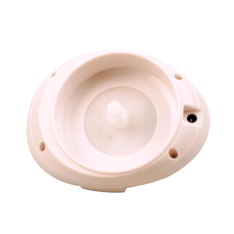 Ergonomic curved handle and soft-touch rubber carry strap of the massager against a light background