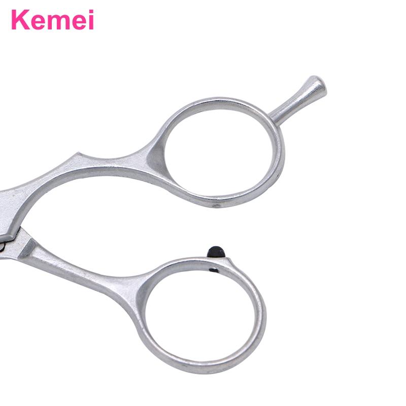 Shaped finger loops and finger rest on hairdressing scissors