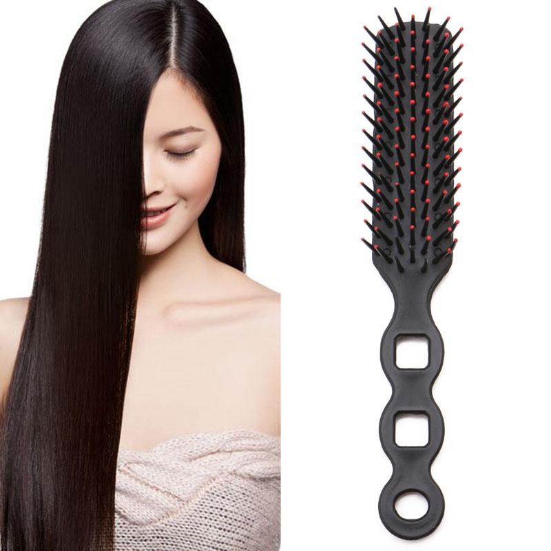 Woman using paddle brush on long dark hair