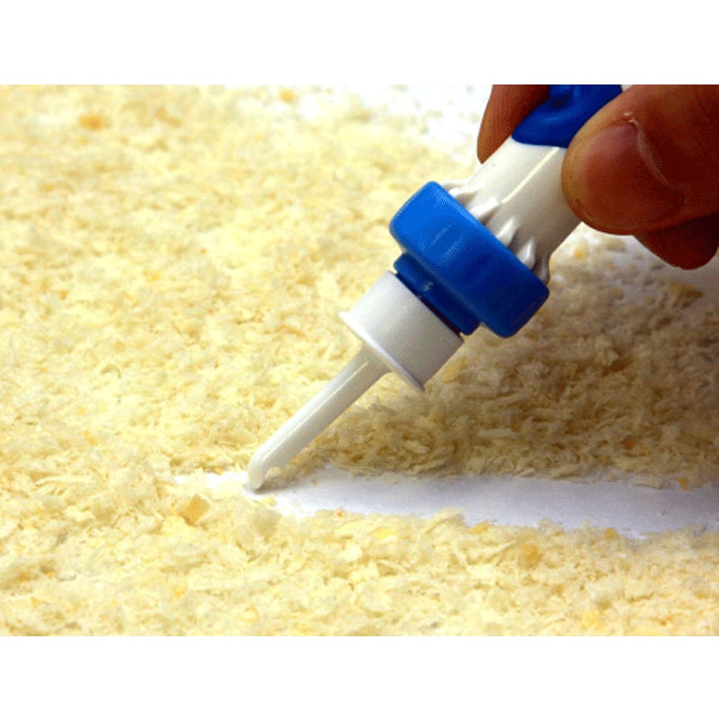 Close-up of ear cleaner tip extracting wax, demonstrating the problem of wax buildup