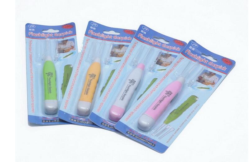 Multiple blister-packaged flashlight ear cleaners in bright colors, displayed on blue backing cards, showing the fun multi-color selection