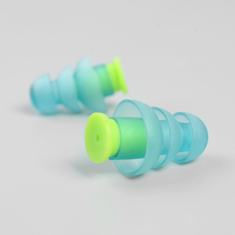 Close-up of disassembled ear plugs showing internal structure and flanged design
