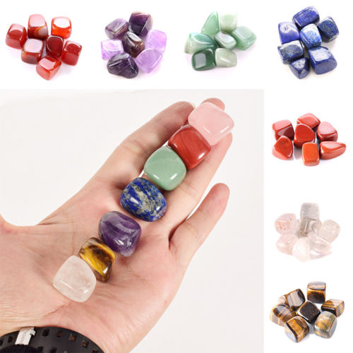 Close‑up of five stones stacked in a hand, showing size and vivid natural colors