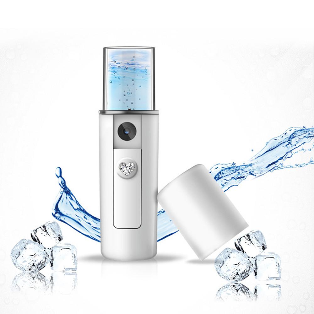 Portable facial steamer surrounded by dynamic water splashes and ice cubes, demonstrating nano-mist technology and refreshing hydration.