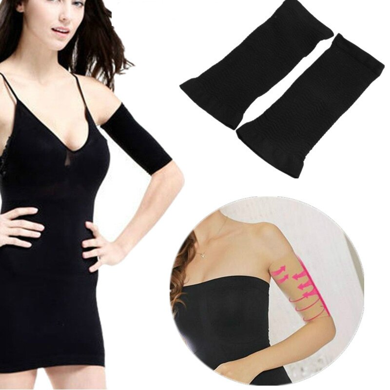 Product pair of black arm sleeves with neon pink and yellow arrow pattern, worn by a woman in a black dress