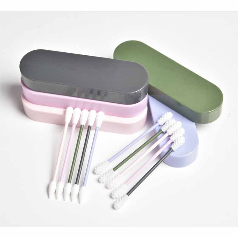 Three reusable silicone swab sets with storage cases in sage green, pale pink, and charcoal, displayed with loose individual swabs showing white and colored brush tips