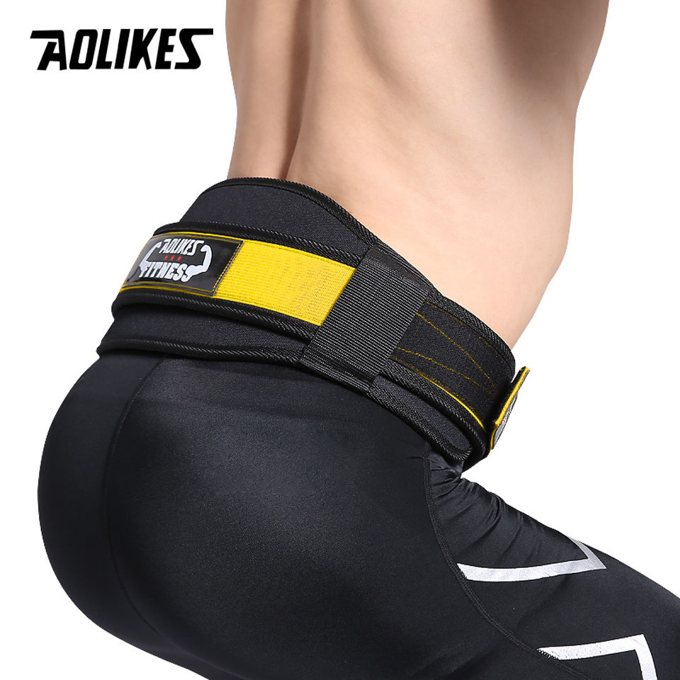 Yellow variant belt worn by a confident athlete, representing the transformed, pain-free lifting experience