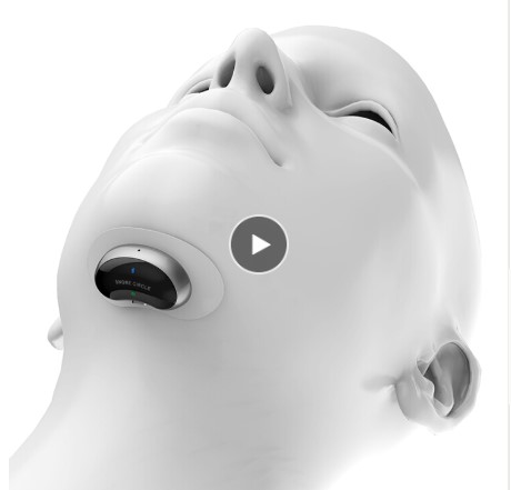 White ergonomic anti-snore biosensor device with adjustable chin strap and teal metallic accent, shot at 45-degree angle