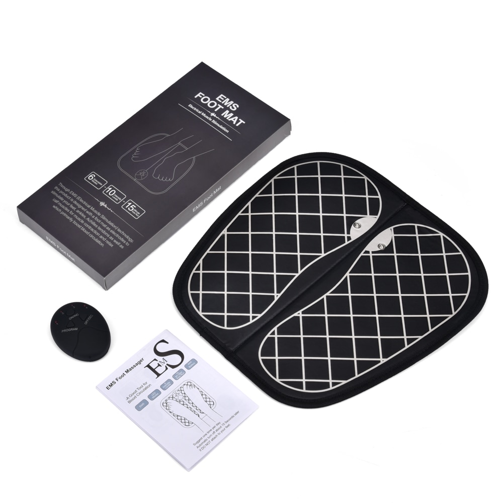 Unboxed EMS foot massage mat kit with mat, control unit, user manual and instruction card on a light surface