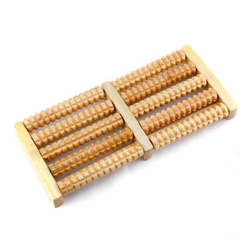 Wooden foot massager with five rows of beads on natural wood tray, angled perspective highlighting roller depth and craftsmanship