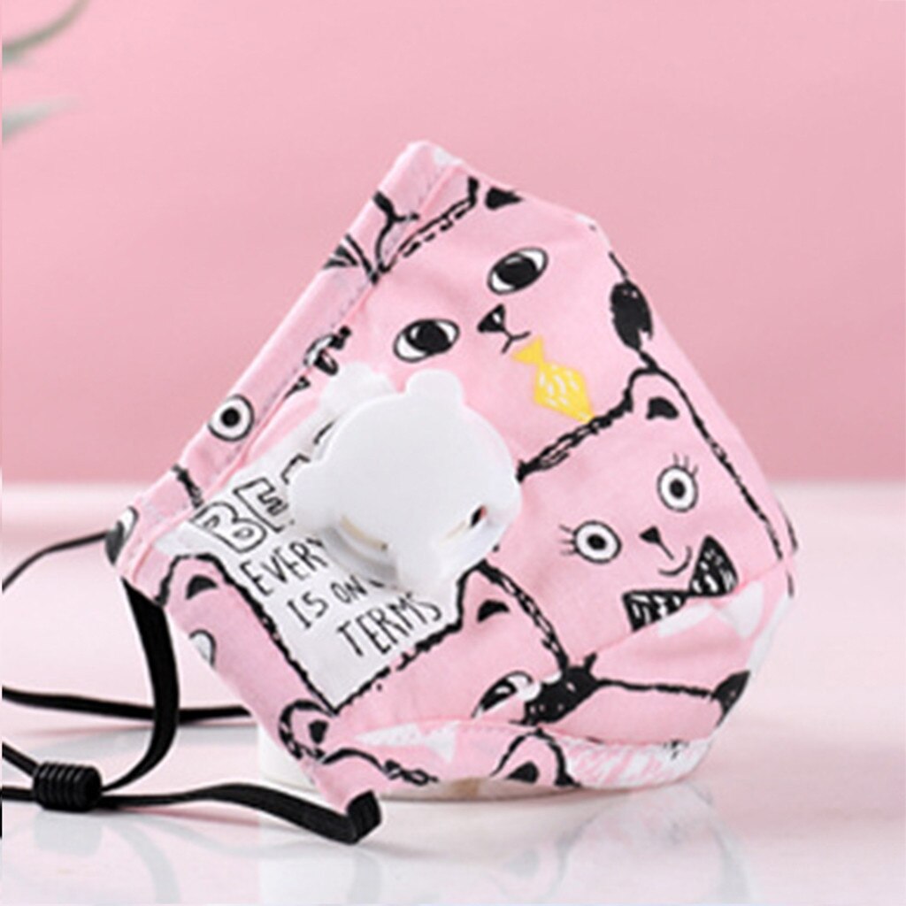 Close-up of a pink cat cartoon mask with expressive eyes and yellow accents, child’s finger pointing at the design, soft daylight