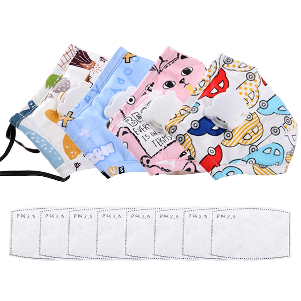 Four colorful cartoon children’s face masks in pink cat, blue bear, pink animal, and vehicle prints, fanned out on warm travertine stone with eucalyptus, filter packs below