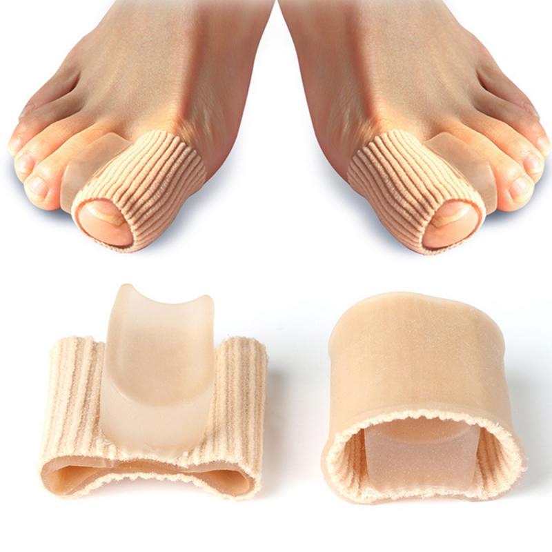 Both feet wearing toe separators, demonstrating comfortable fit and proper alignment of the first and second toe