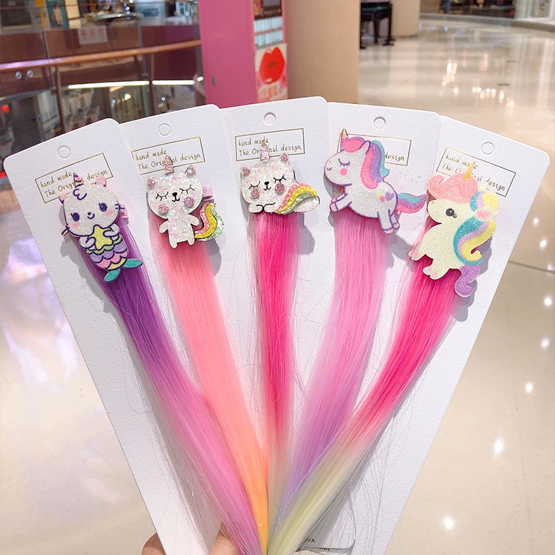 Packaged cartoon hair clips in pastel rainbow colors