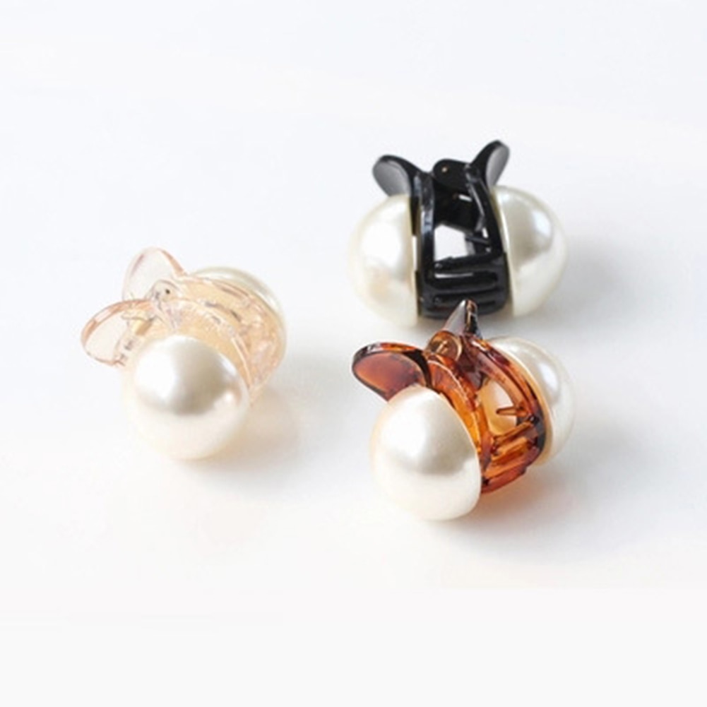 Close detail of rounded faux pearl claw clip