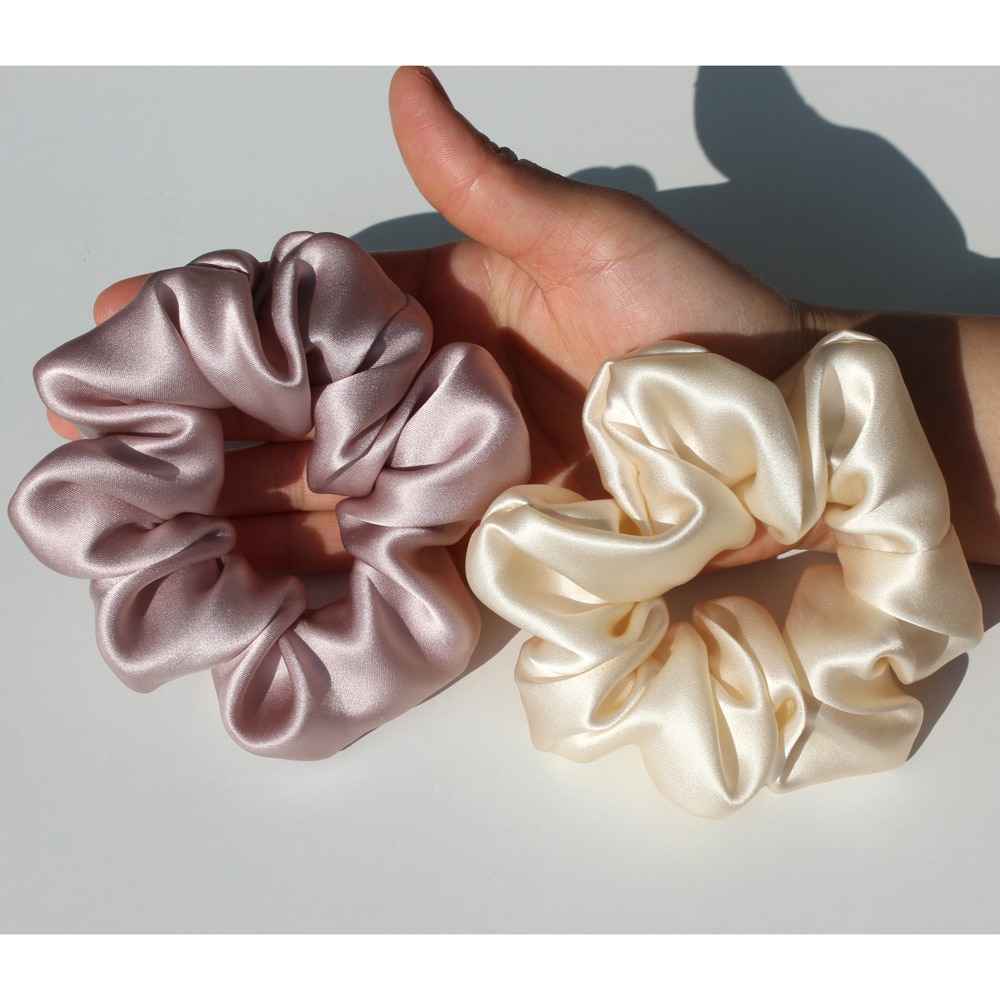 Hand showing flexible oversized silk scrunchies