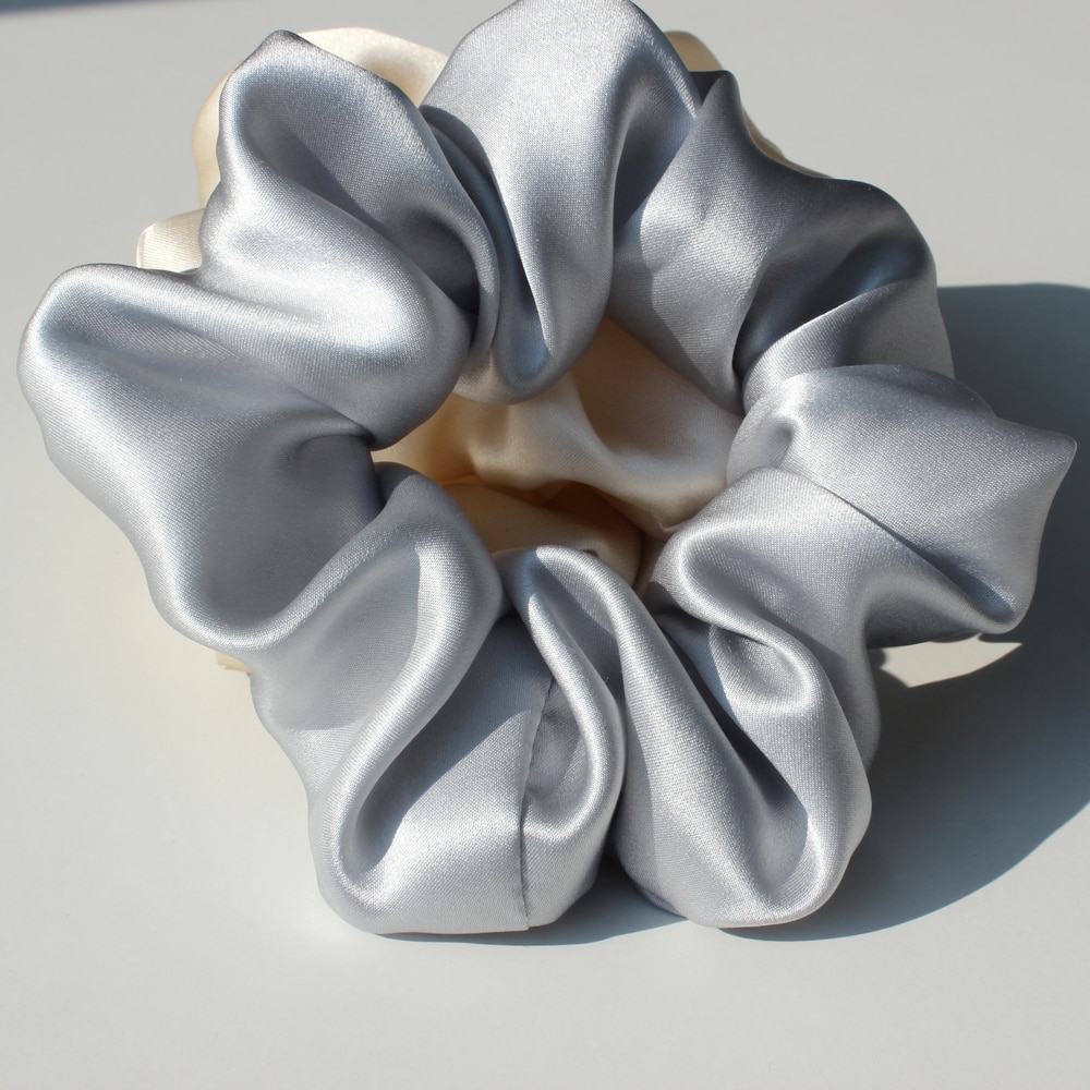Close detail of silver gathered silk fabric