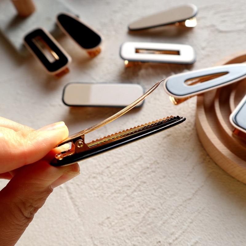 Open barrette showing its metal spring clasp