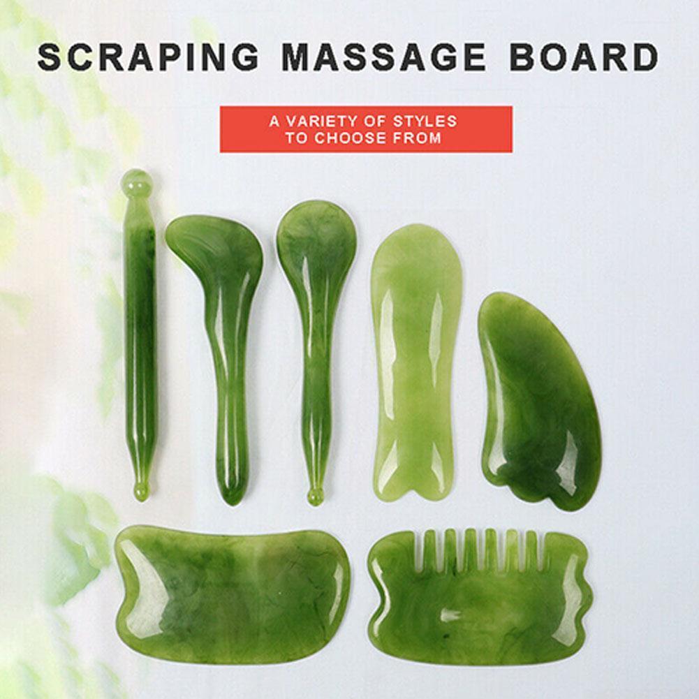 Seven-piece jade gua sha massage tool set with watercolor leaf background
