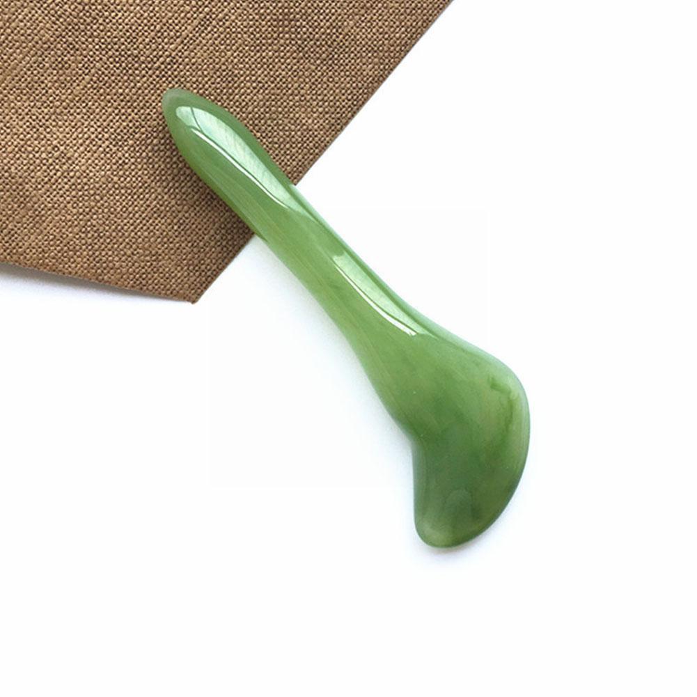 Single jade gua sha tool on textured fabric, symbolising the old way of incomplete self‑care