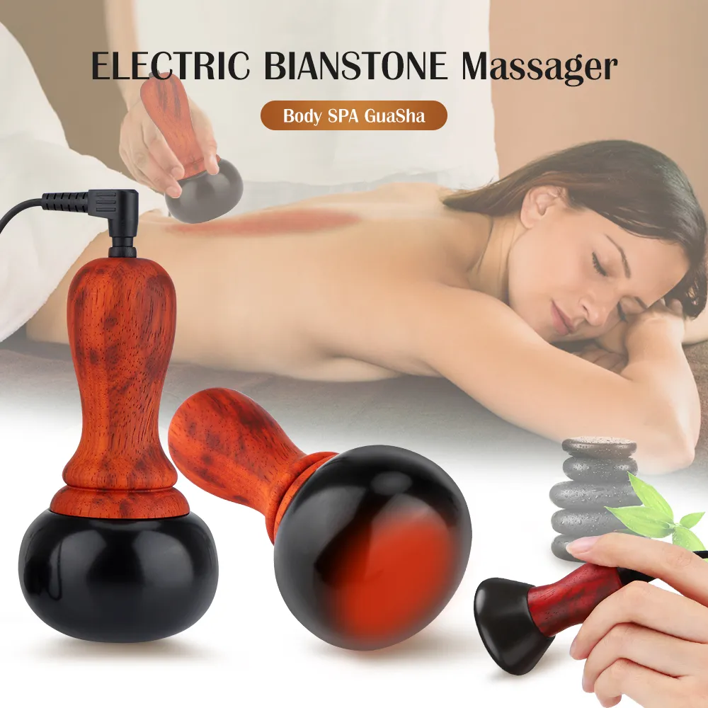 Electric gua sha massager with rosewood handle, two ceramic heads, and glowing heat effect, shown on ivory ribbed glass.
