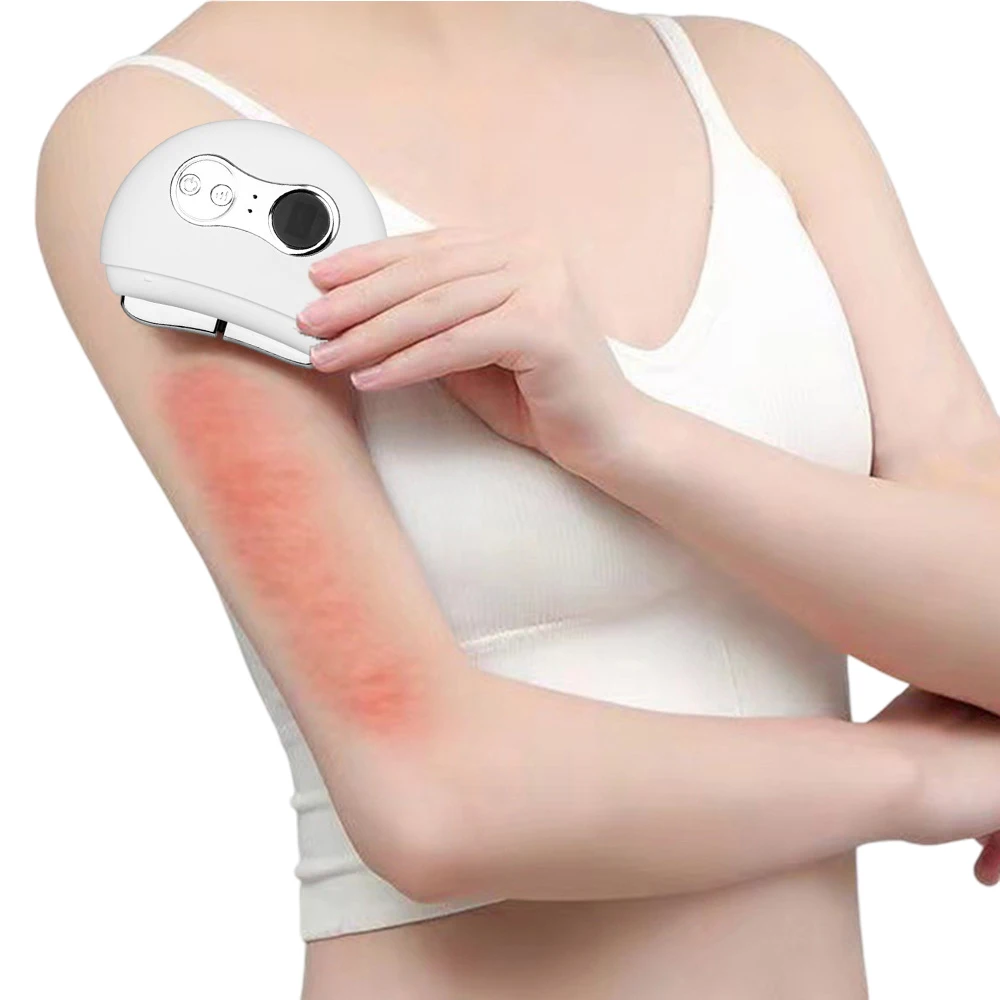 Woman holding white electric gua sha device against upper arm with visible redness, demonstrating treatment activation