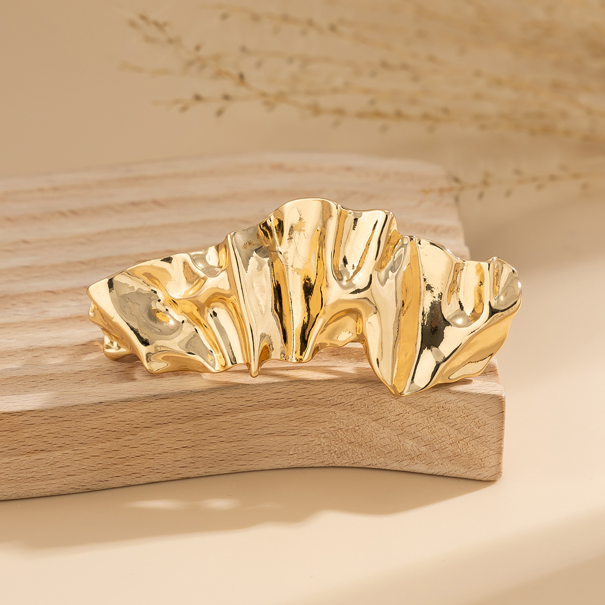 Close view of folded gold metal hair clip