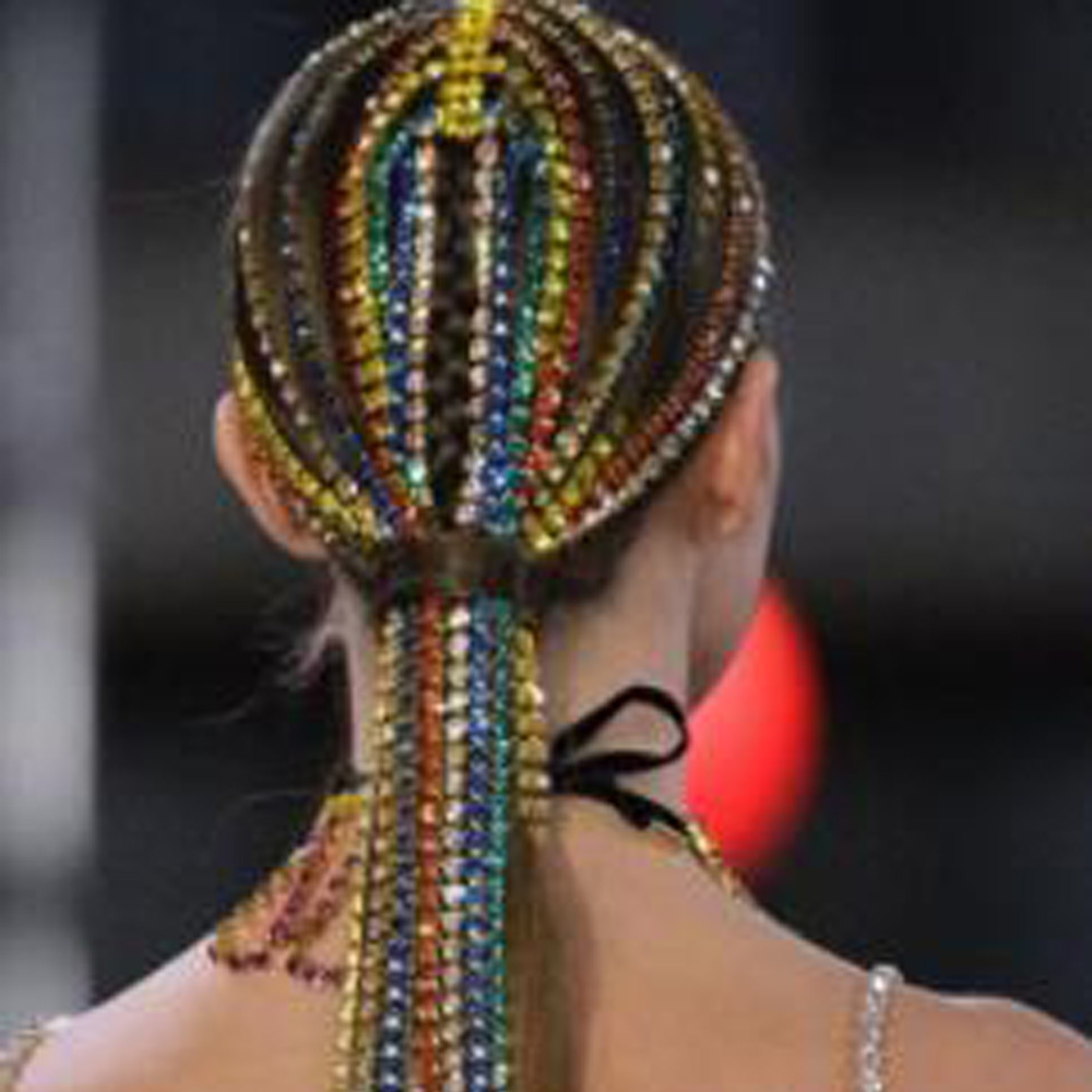 Rhinestone tassel headpiece worn over sleek ponytail