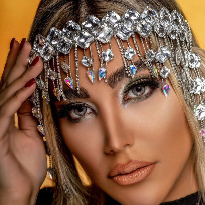 Crystal hair chain worn across forehead with cascading sparkle