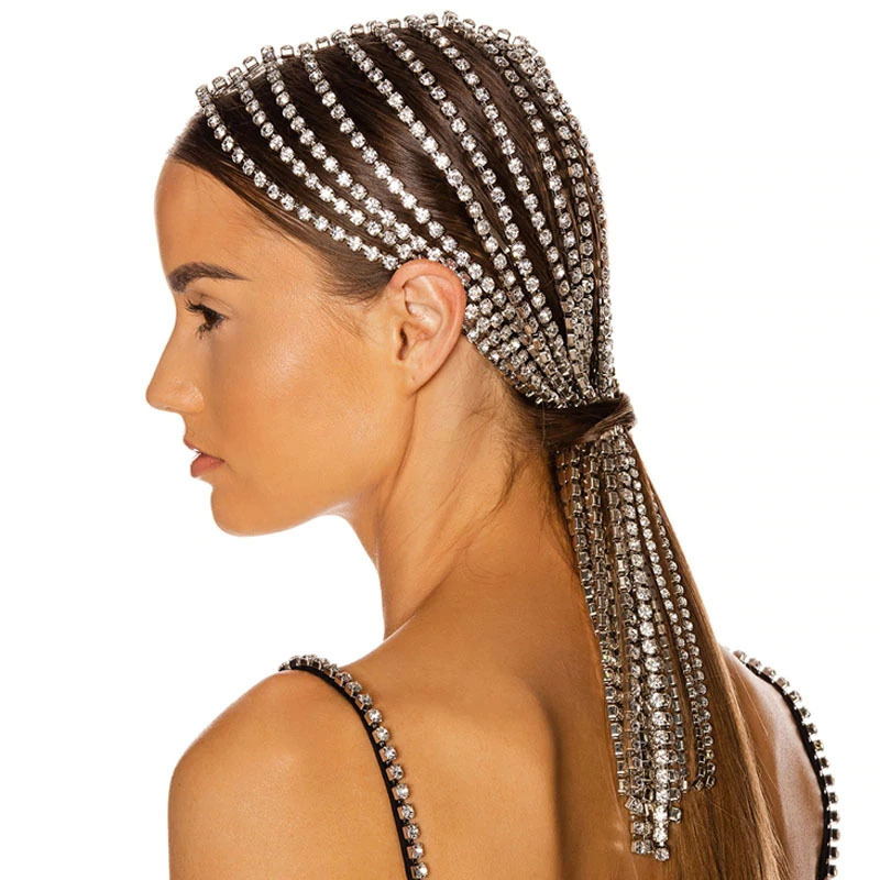 Woman styling rhinestone headpiece with sleek ponytail