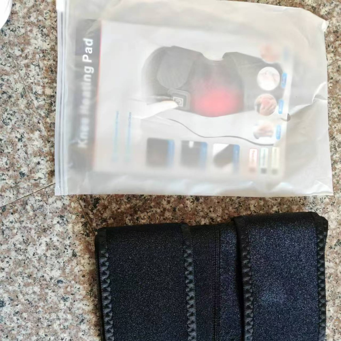 Packaged heated knee wraps inside a clear plastic pouch with 'Heating Pad' label, showing the complete solution