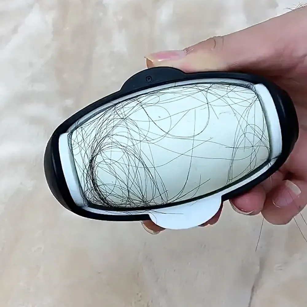 A hand gripping the penguin-shaped lint roller comfortably, showing the non-slip ergonomic design