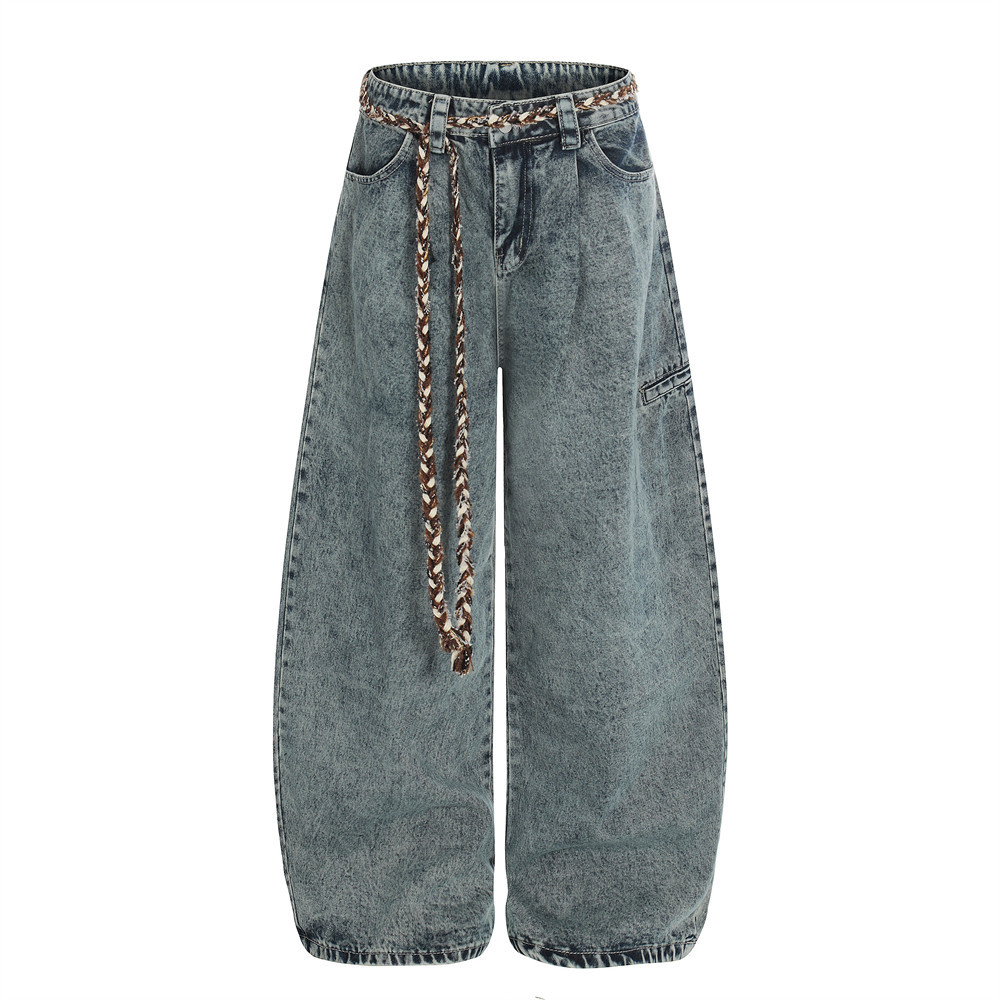 Loose jeans curved hem ankle detail close-up