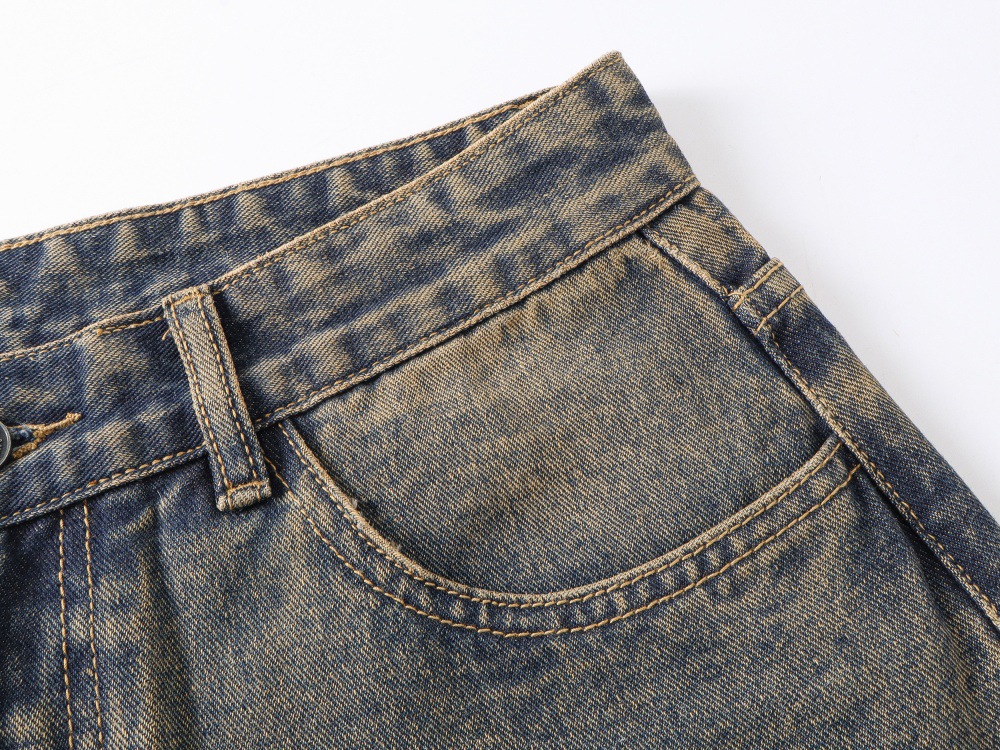 Distressed denim jeans hip and thigh loose fit detail