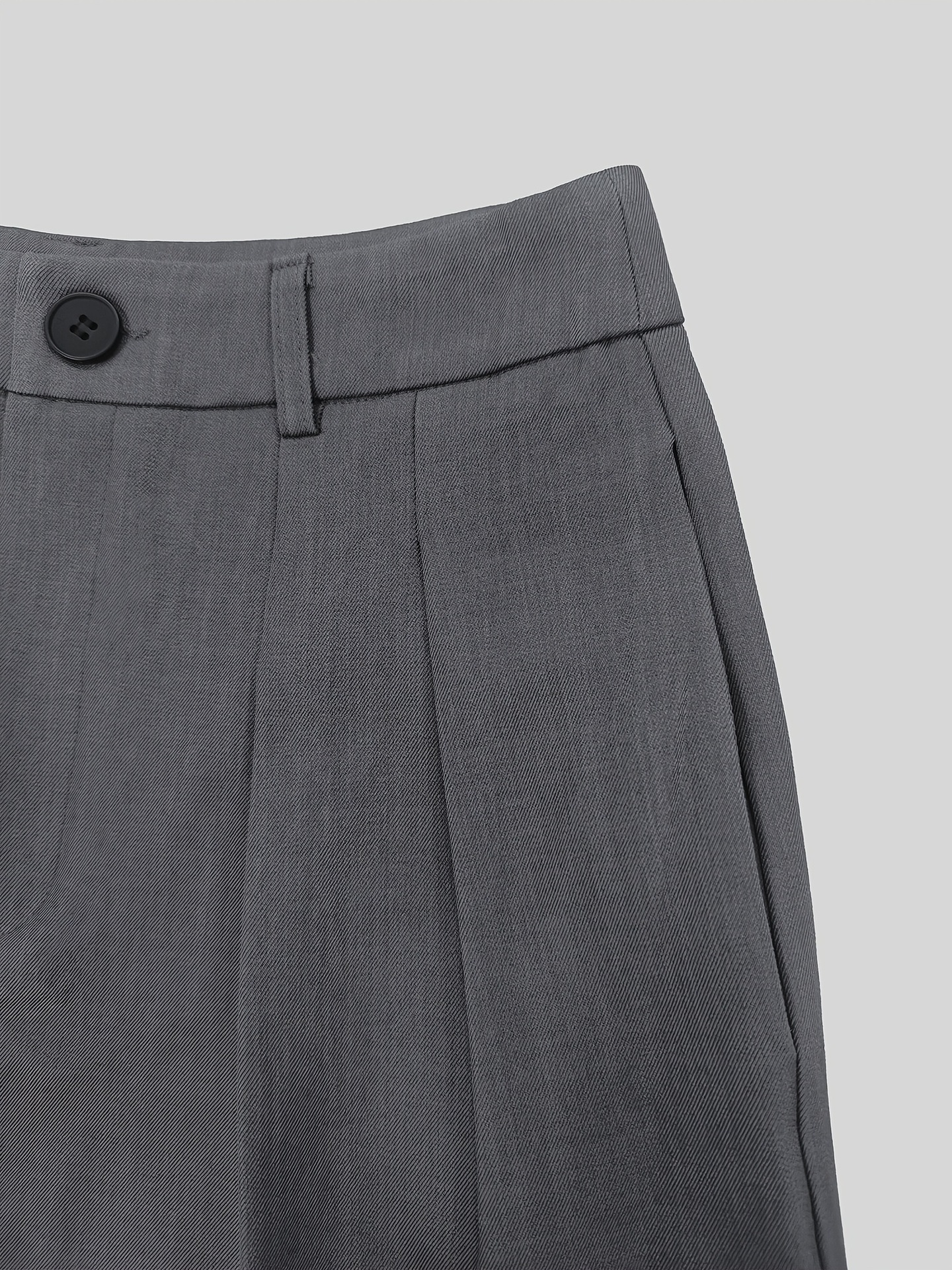 Close-up of adjustable detachable shoulder strap and pocket detail on wide leg pants